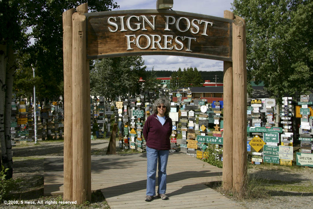 Susie at the entrance to the Sign Post Forest in Watson Lake, YT